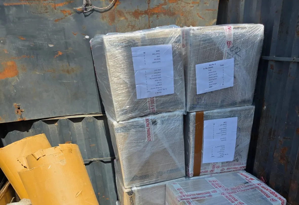 Numbered household cartons stretch-wrapped in the packing bay